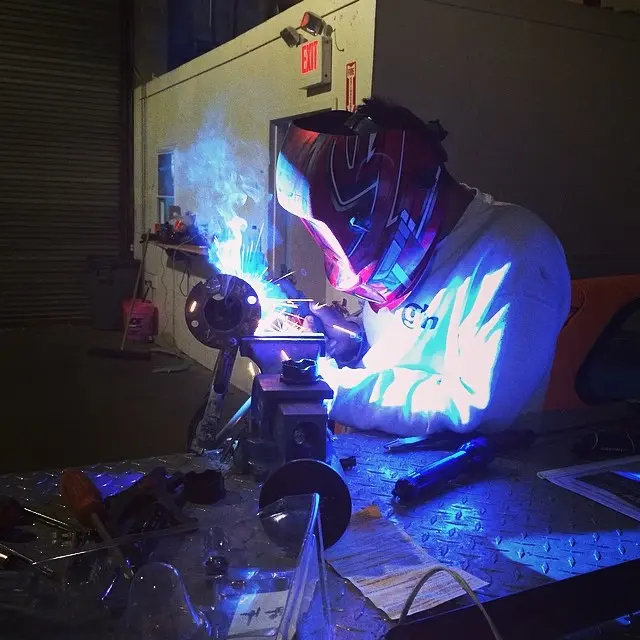 A J6 fabricator welding in the shop